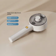 A handheld white and silver hair cleaning brush with a transparent cover, shown on a light blue background with feature callouts in Chinese. The product has a white handle, a gold button, and a circular brush head with a clear top.