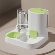 Pet feeder and water dispenser with green accents on a gray surface