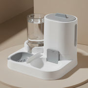 Pet water and food dispenser on a gray surface with a gray background